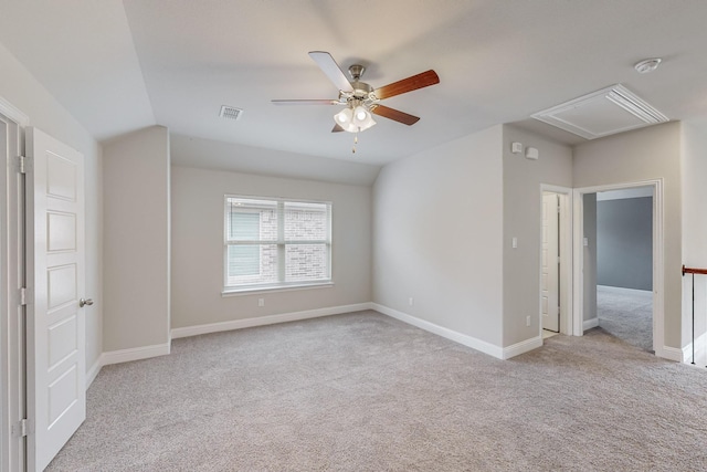 interior space with vaulted ceiling, light carpet, and ceiling fan