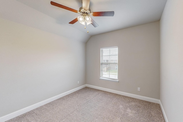 carpeted empty room with ceiling fan and vaulted ceiling