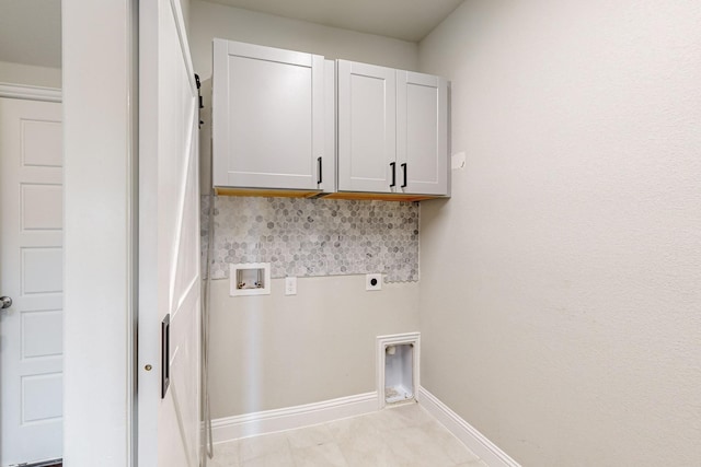 washroom featuring cabinets, hookup for a washing machine, and hookup for an electric dryer