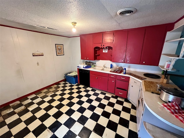 kitchen featuring a textured ceiling, black dishwasher, and sink