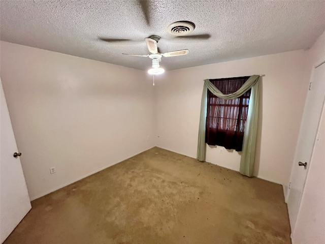 unfurnished room featuring ceiling fan, a textured ceiling, and light carpet