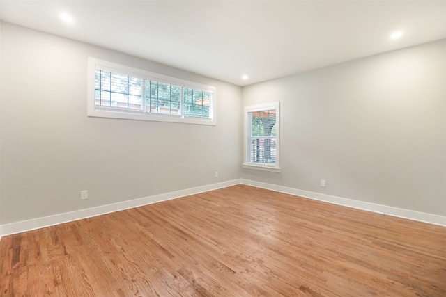 empty room featuring plenty of natural light and light hardwood / wood-style floors