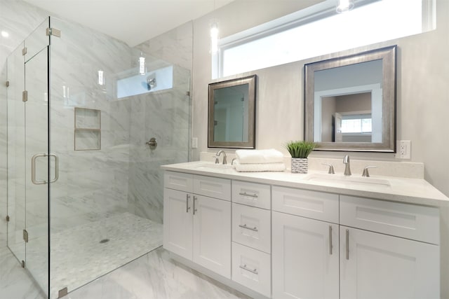 bathroom featuring a shower with door, double sink vanity, and tile patterned flooring