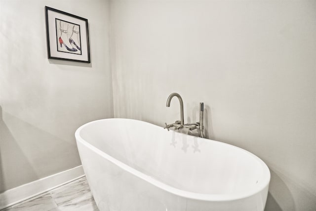 bathroom featuring tile patterned flooring and a tub