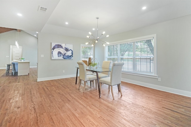 dining room featuring a wealth of natural light, a notable chandelier, and light hardwood / wood-style floors