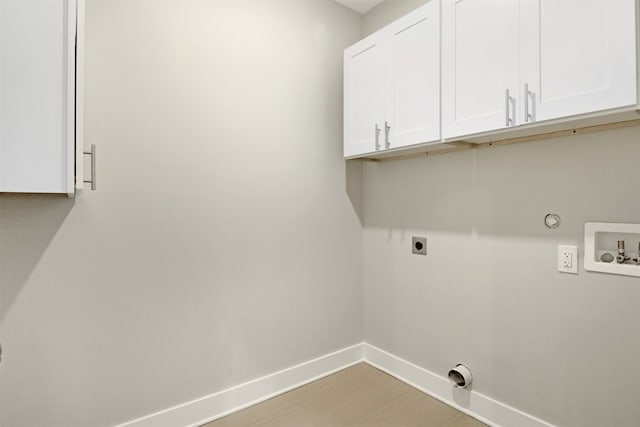 laundry area featuring gas dryer hookup, cabinets, electric dryer hookup, and washer hookup