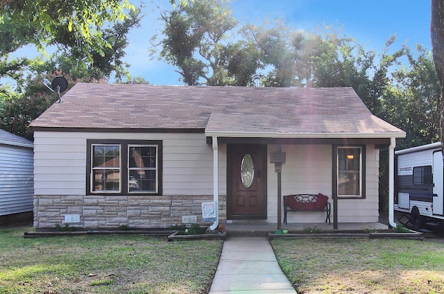 bungalow-style home with a front yard