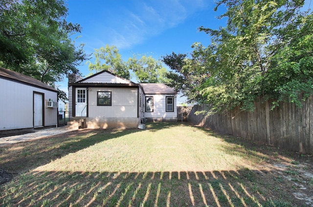 back of house featuring a lawn