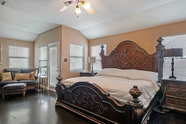 bedroom with multiple windows, ceiling fan, wood-type flooring, and vaulted ceiling