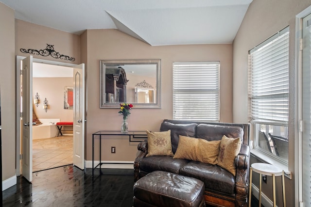 living area featuring dark tile patterned flooring and vaulted ceiling