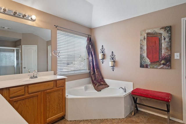 bathroom with vanity, tile patterned floors, and a tub