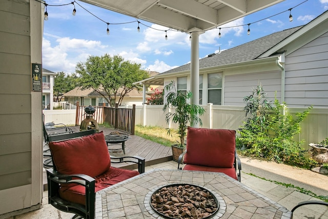 view of patio featuring a wooden deck and a fire pit