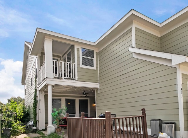 back of house with a balcony and ceiling fan