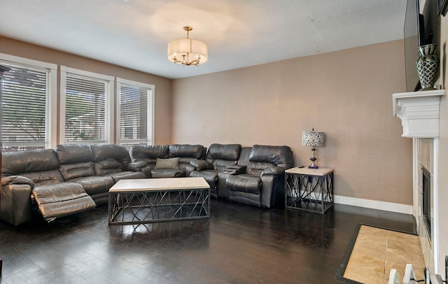 living room featuring dark hardwood / wood-style floors and a chandelier