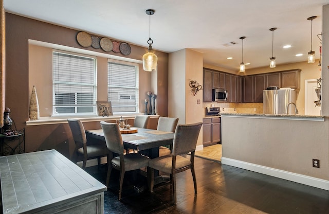 dining room featuring hardwood / wood-style flooring and sink