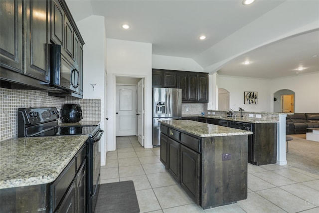 kitchen featuring sink, tasteful backsplash, a center island, light tile patterned floors, and black appliances