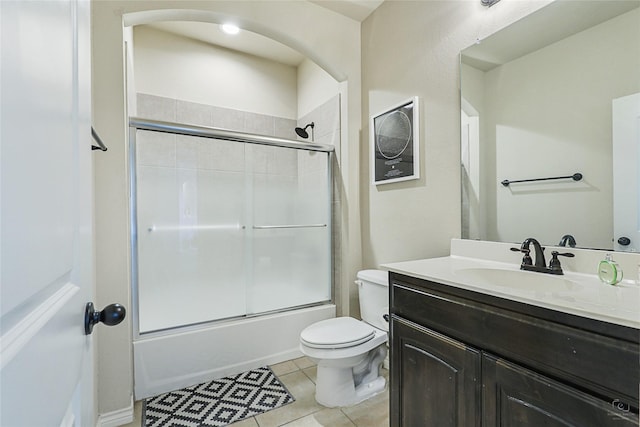 full bathroom with vanity, tile patterned floors, enclosed tub / shower combo, and toilet