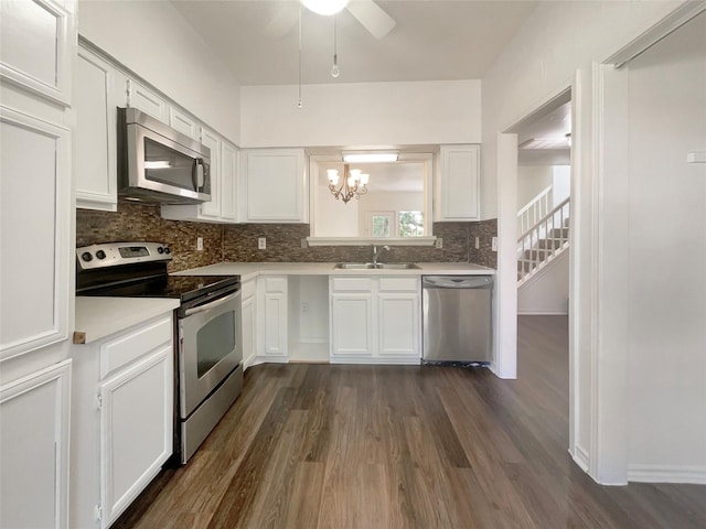 kitchen with stainless steel appliances, white cabinetry, and sink