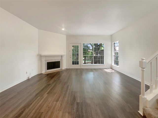 unfurnished living room with dark hardwood / wood-style floors