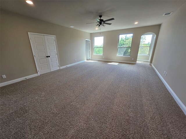 spare room featuring ceiling fan and carpet