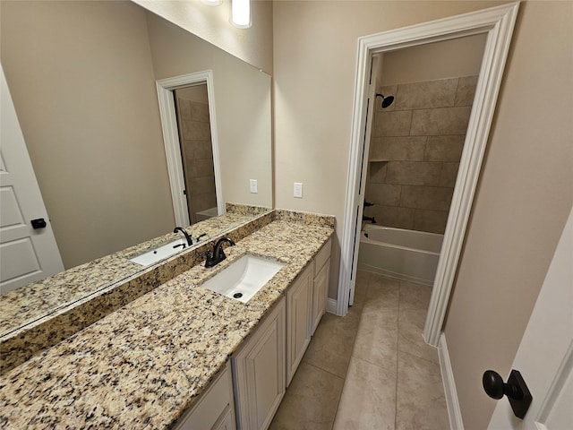 bathroom featuring vanity, tile patterned floors, and tiled shower / bath