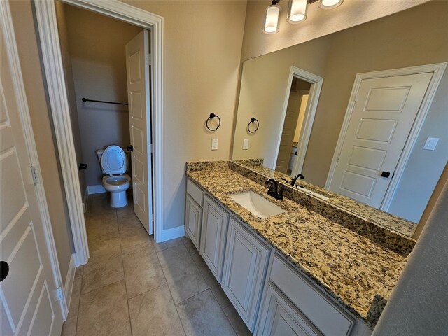 bathroom featuring vanity, toilet, and tile patterned floors