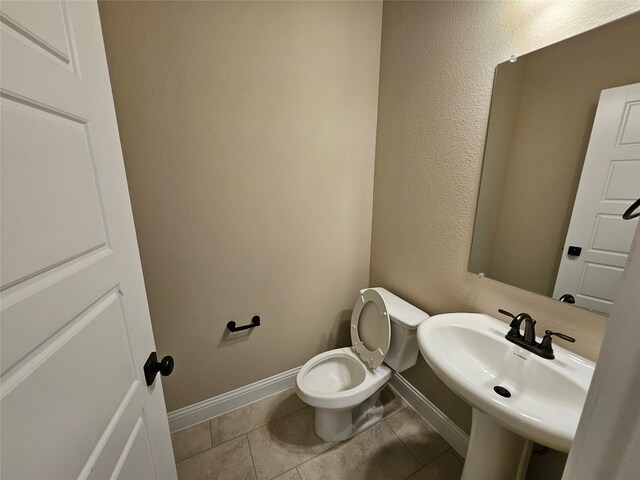 bathroom with sink, tile patterned floors, and toilet