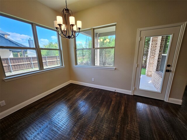 interior space with an inviting chandelier, plenty of natural light, and dark wood-type flooring