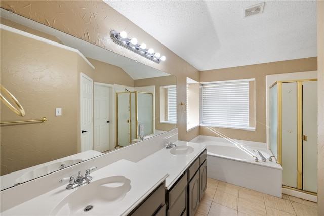 bathroom featuring double vanity, separate shower and tub, tile patterned floors, and a textured ceiling