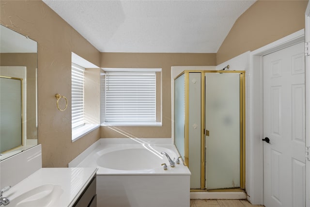 bathroom featuring plus walk in shower, vanity, vaulted ceiling, a textured ceiling, and tile patterned flooring