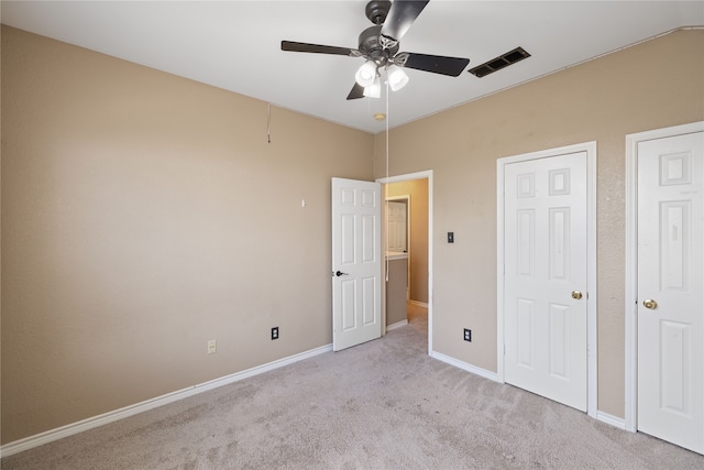 unfurnished bedroom with light carpet and ceiling fan