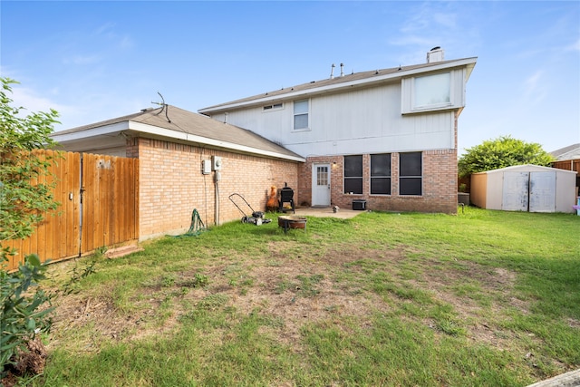 rear view of property featuring a yard and a shed