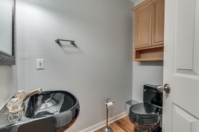 bathroom featuring hardwood / wood-style floors, sink, and toilet