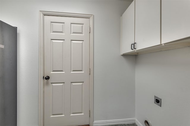 clothes washing area with cabinets and hookup for an electric dryer