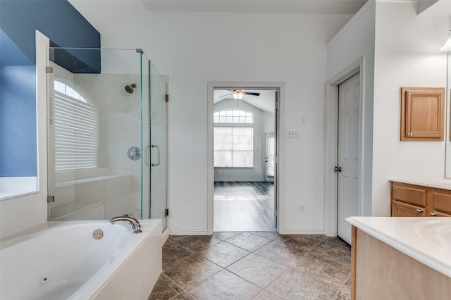 bathroom with vaulted ceiling, shower with separate bathtub, and vanity