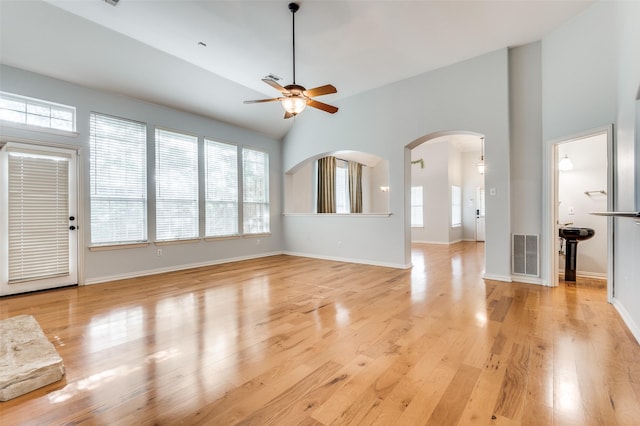 unfurnished living room featuring ceiling fan, high vaulted ceiling, and light hardwood / wood-style flooring