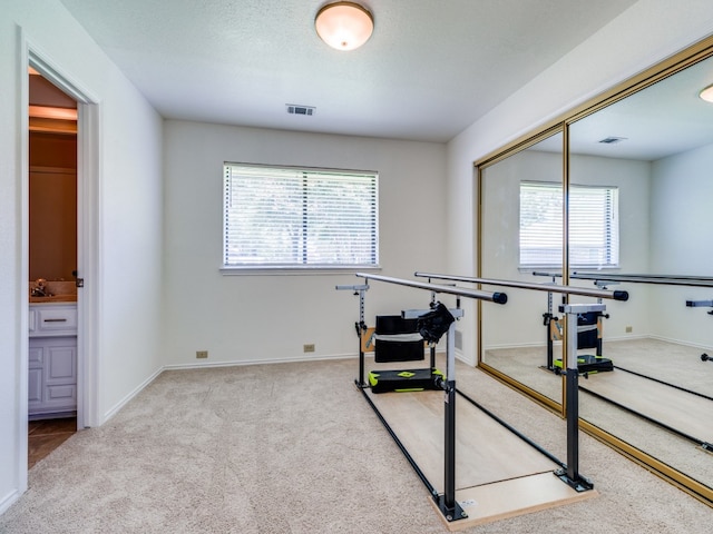 game room with carpet floors, sink, and a healthy amount of sunlight