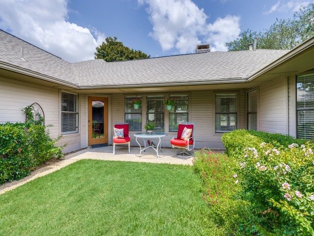 back of property featuring a patio and a yard