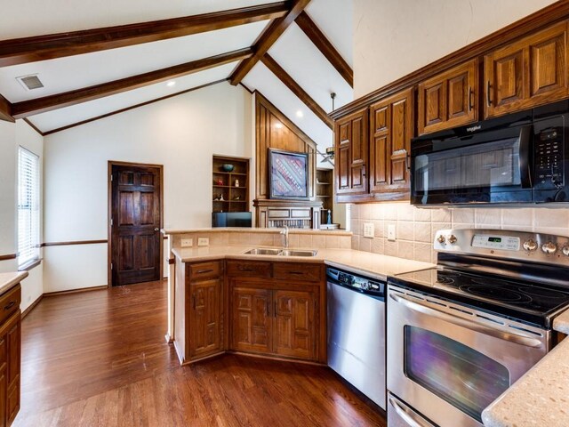 kitchen featuring beam ceiling, dark hardwood / wood-style flooring, stainless steel appliances, sink, and high vaulted ceiling