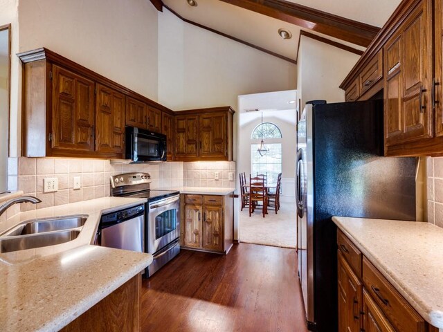 kitchen featuring tasteful backsplash, dark hardwood / wood-style flooring, light stone counters, black appliances, and sink