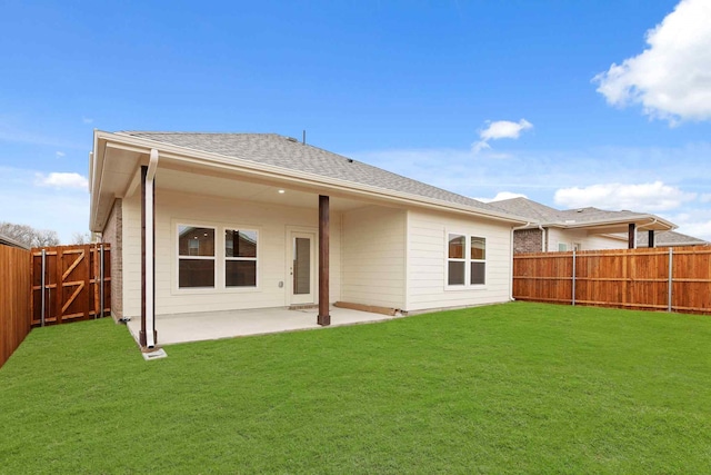 back of house featuring a patio area and a lawn