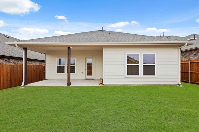 back of property featuring a lawn and a patio