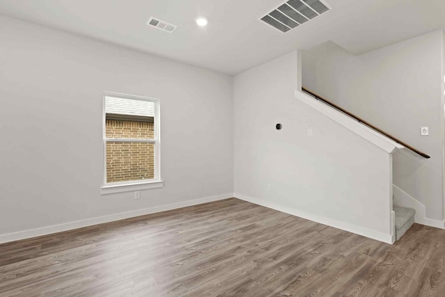 unfurnished room with hardwood / wood-style floors