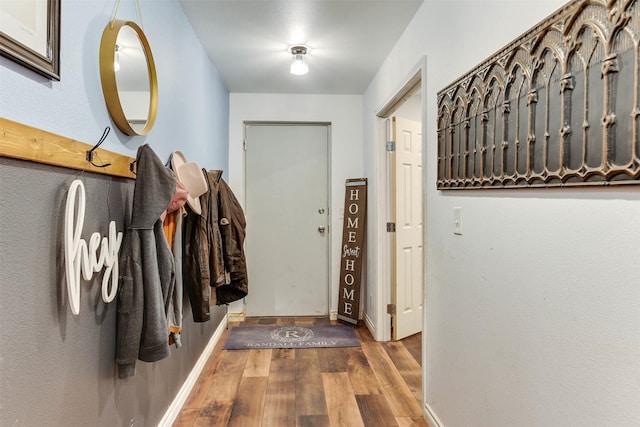 entryway featuring baseboards and wood finished floors