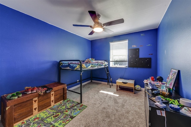 carpeted bedroom with ceiling fan and baseboards