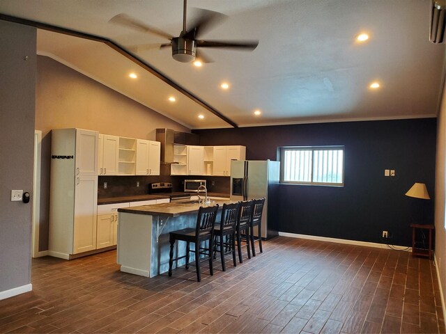 kitchen featuring stainless steel appliances, dark hardwood / wood-style floors, white cabinetry, ceiling fan, and wall chimney exhaust hood