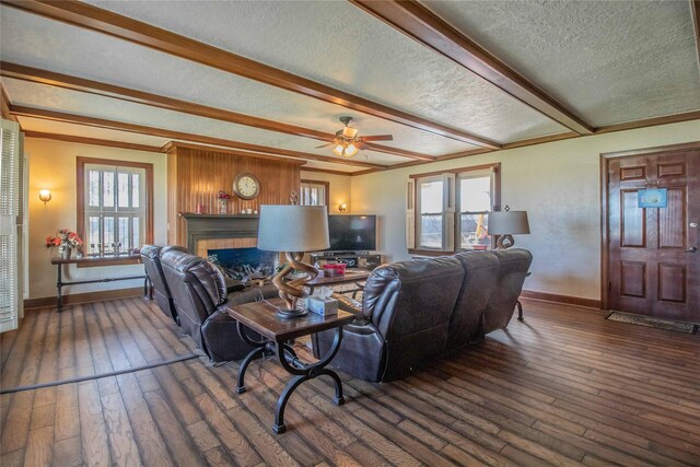 living room with plenty of natural light, beamed ceiling, and dark hardwood / wood-style floors