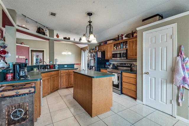 kitchen featuring pendant lighting, sink, stainless steel appliances, light tile patterned flooring, and kitchen peninsula