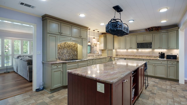 kitchen with ornamental molding, black electric cooktop, light tile patterned floors, and hanging light fixtures