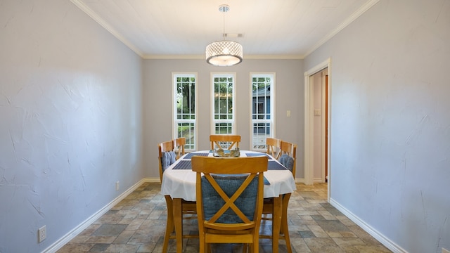 dining room with ornamental molding and tile patterned floors